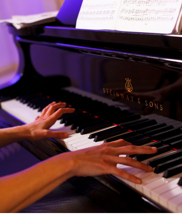 concert summer in Munich Hands playing the piano, sheet music on the piano, elegant atmosphere.