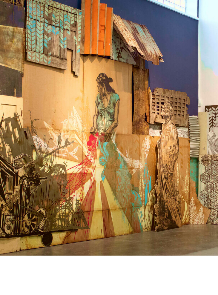Art in Munich Wall art installation made of painted wood and cardboard with figures and patterns in a modern exhibition space.